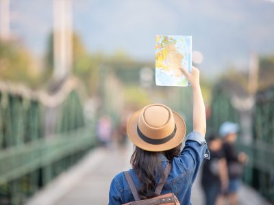 Female tourists on hand have a happy travel map.